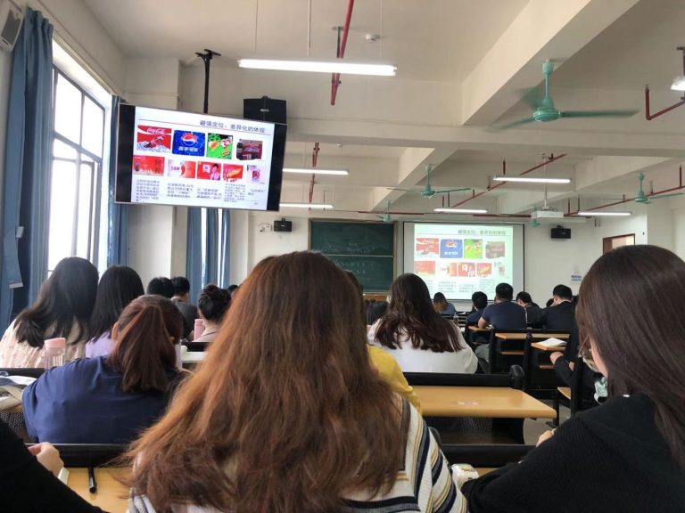 Students using tablets and laptops in a classroom