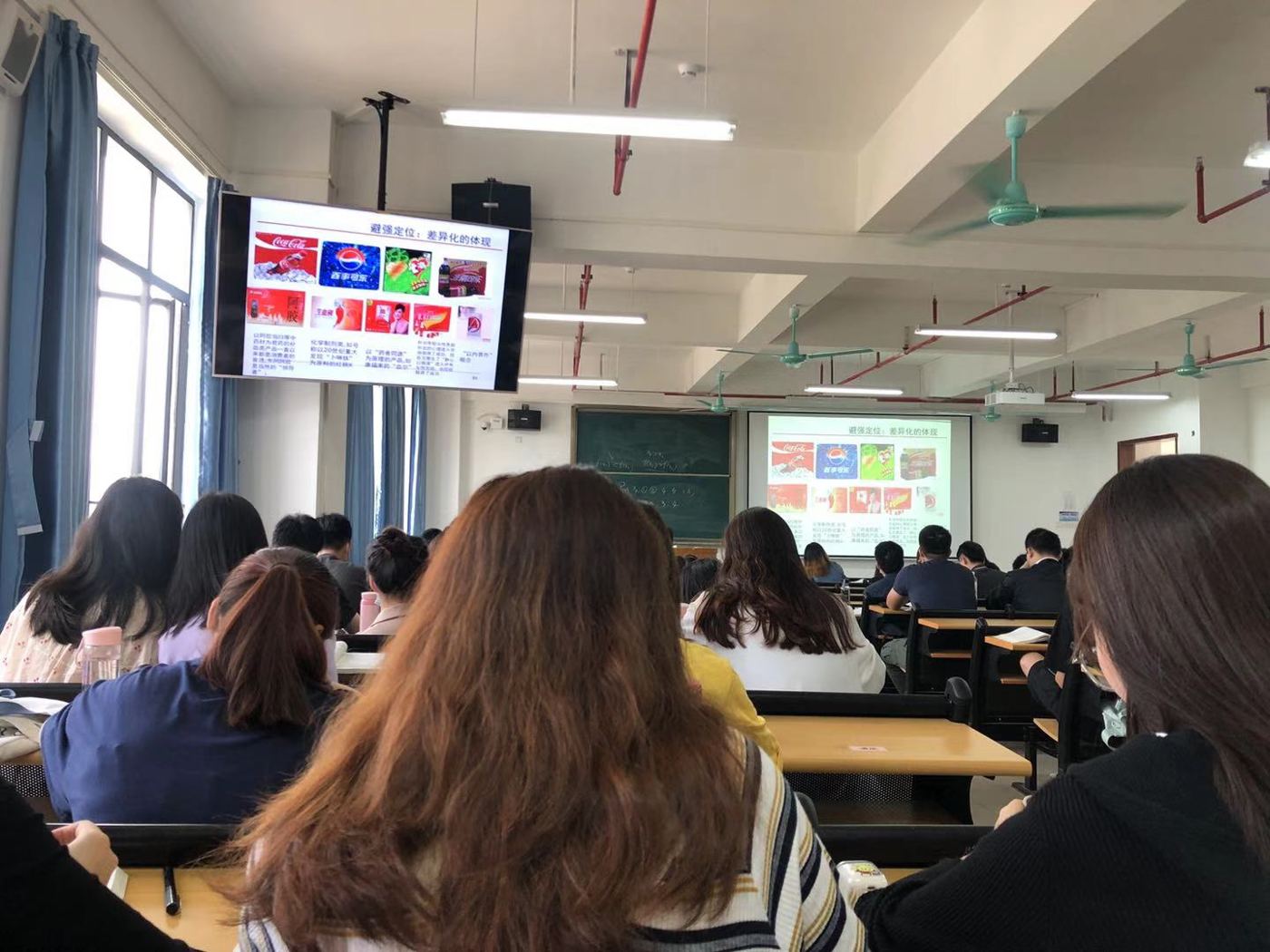 Students using tablets and laptops in a classroom