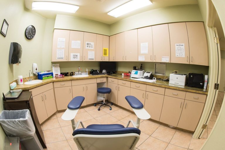 Patients sit in a bright community clinic waiting room before their appointments.